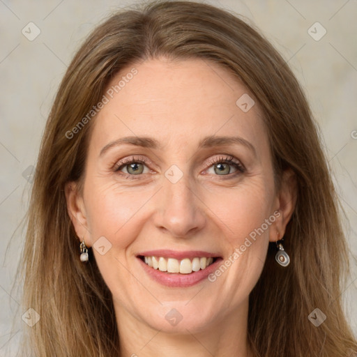 Joyful white adult female with long  brown hair and green eyes