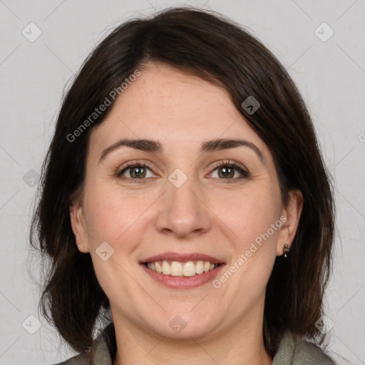 Joyful white adult female with medium  brown hair and brown eyes