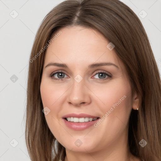 Joyful white young-adult female with long  brown hair and grey eyes