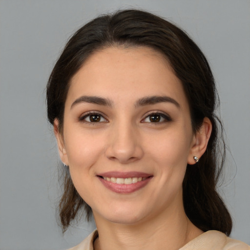 Joyful white young-adult female with medium  brown hair and brown eyes