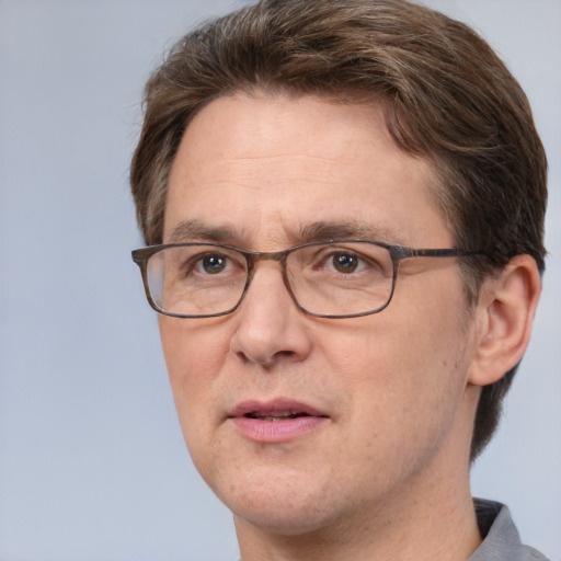 Joyful white adult male with short  brown hair and grey eyes