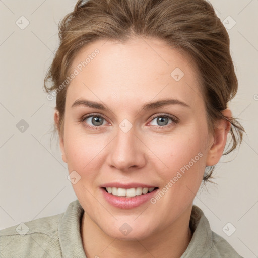 Joyful white young-adult female with medium  brown hair and blue eyes