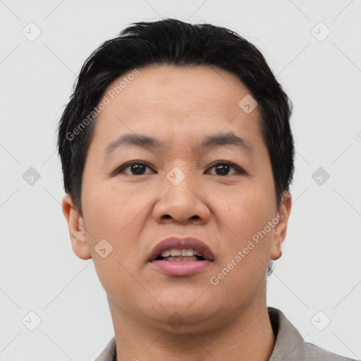 Joyful asian adult male with short  black hair and brown eyes