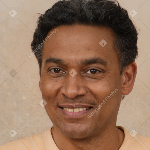 Joyful latino adult male with short  brown hair and brown eyes