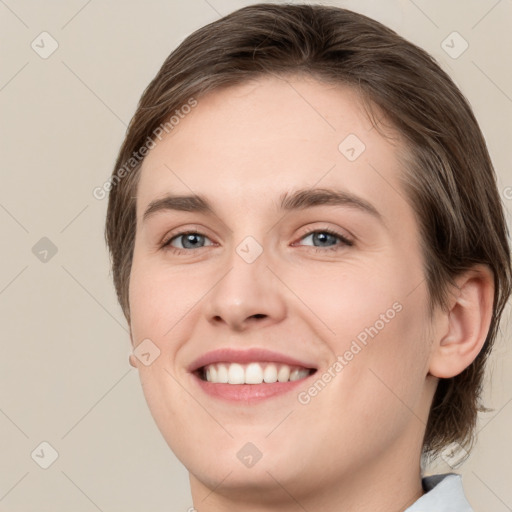 Joyful white young-adult female with medium  brown hair and green eyes