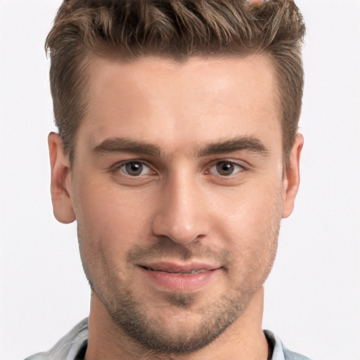 Joyful white young-adult male with short  brown hair and brown eyes