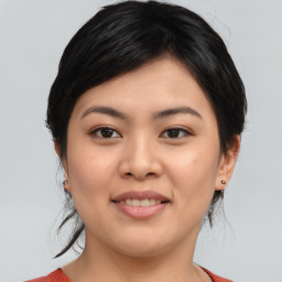 Joyful asian young-adult female with medium  black hair and brown eyes