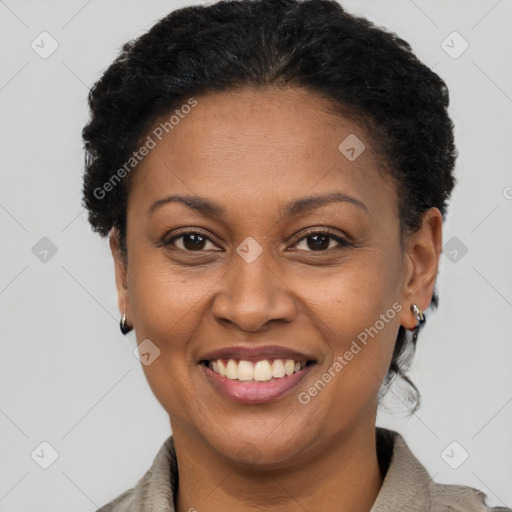 Joyful black adult female with short  brown hair and brown eyes