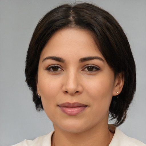 Joyful latino young-adult female with medium  brown hair and brown eyes