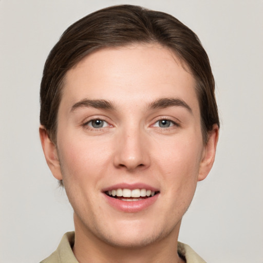 Joyful white young-adult female with short  brown hair and grey eyes