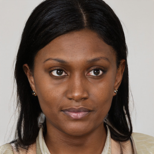 Neutral black young-adult female with medium  brown hair and brown eyes