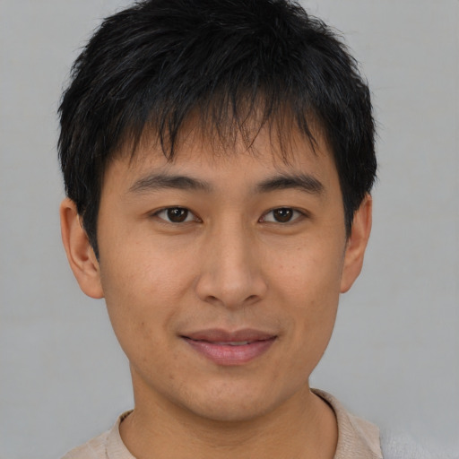 Joyful asian young-adult male with short  brown hair and brown eyes