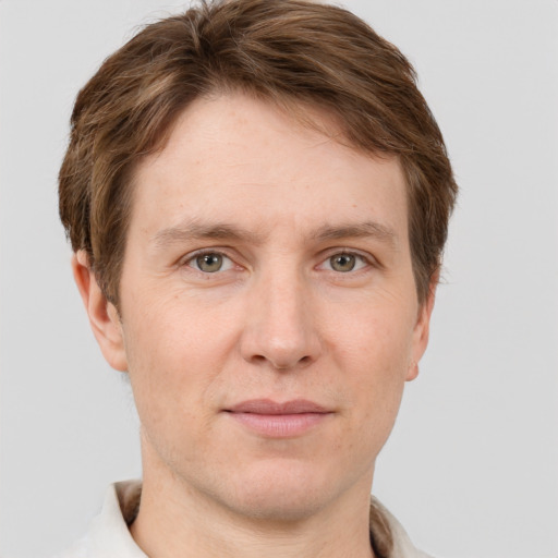 Joyful white adult male with short  brown hair and grey eyes