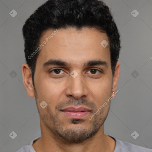 Joyful latino young-adult male with short  black hair and brown eyes