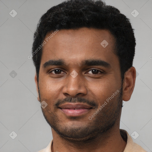 Joyful black young-adult male with short  black hair and brown eyes
