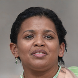 Joyful black adult female with short  brown hair and brown eyes