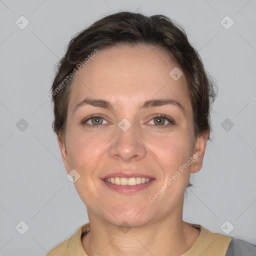 Joyful white adult female with short  brown hair and grey eyes