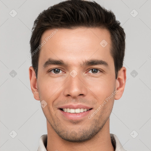 Joyful white young-adult male with short  brown hair and brown eyes