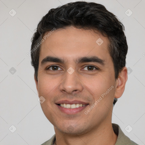 Joyful white young-adult male with short  black hair and brown eyes