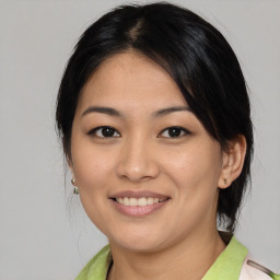 Joyful asian young-adult female with medium  brown hair and brown eyes