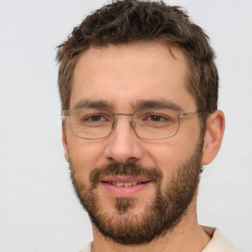 Joyful white adult male with short  brown hair and brown eyes