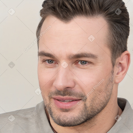 Joyful white adult male with short  brown hair and brown eyes