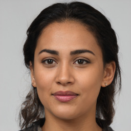 Joyful latino young-adult female with medium  brown hair and brown eyes