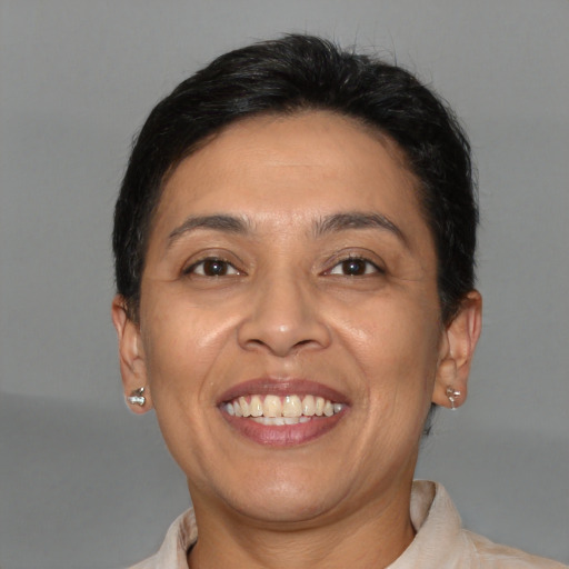 Joyful latino adult female with short  brown hair and brown eyes