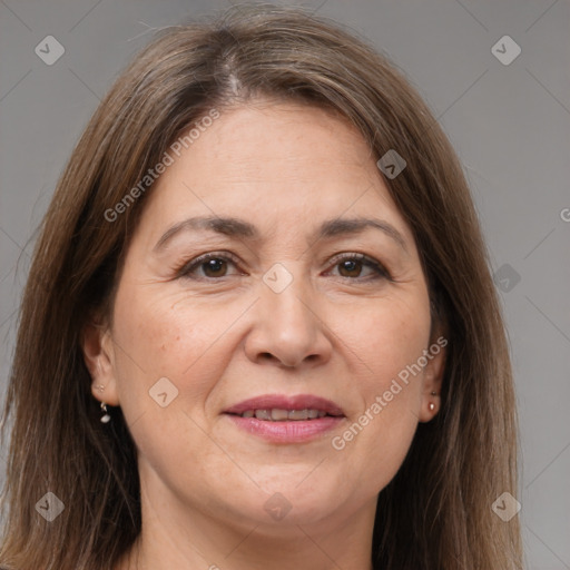 Joyful white adult female with long  brown hair and brown eyes