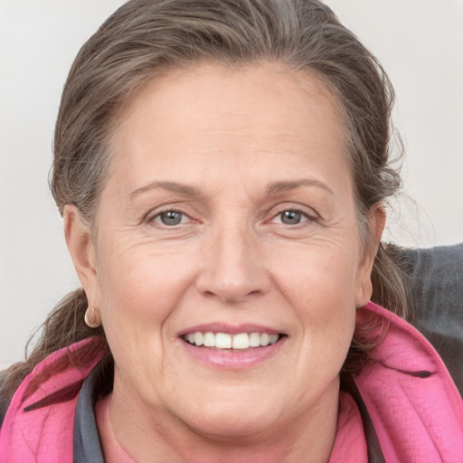 Joyful white adult female with medium  brown hair and grey eyes