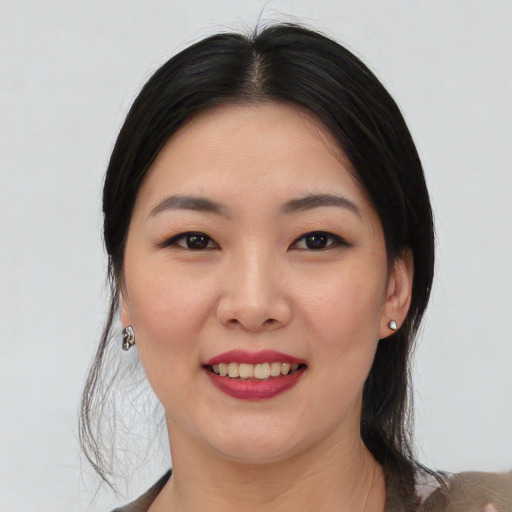 Joyful white young-adult female with medium  black hair and brown eyes
