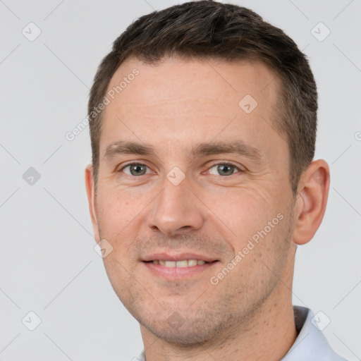 Joyful white adult male with short  brown hair and brown eyes