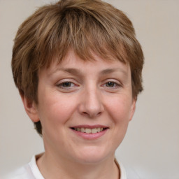 Joyful white adult female with short  brown hair and grey eyes