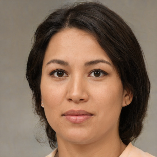 Joyful asian young-adult female with medium  brown hair and brown eyes