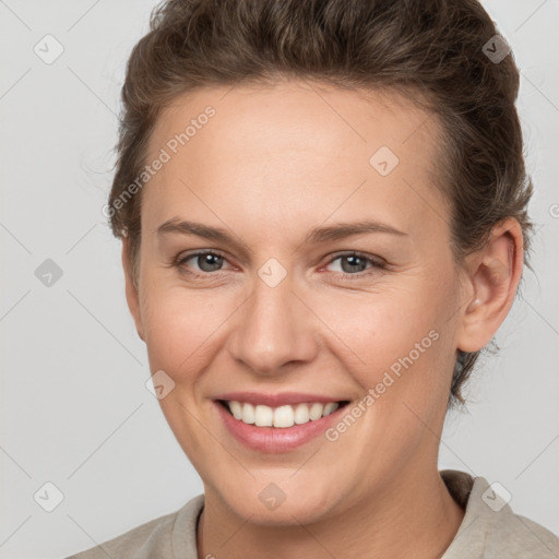 Joyful white young-adult female with short  brown hair and brown eyes