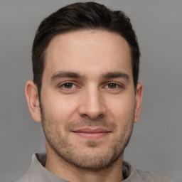 Joyful white young-adult male with short  brown hair and brown eyes