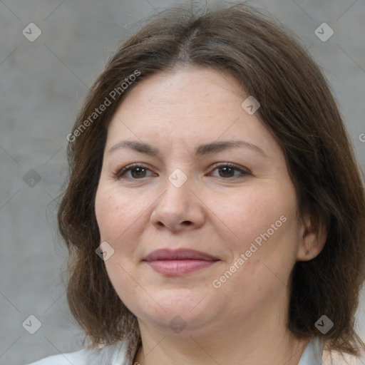 Joyful white adult female with medium  brown hair and brown eyes