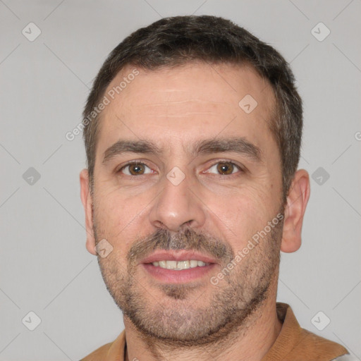 Joyful white adult male with short  brown hair and brown eyes