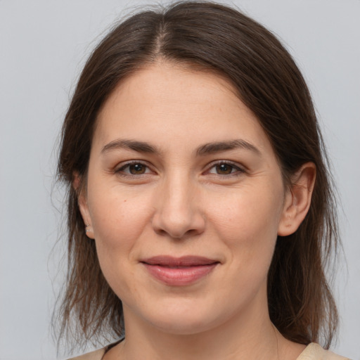 Joyful white young-adult female with medium  brown hair and brown eyes