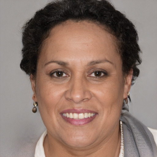 Joyful latino adult female with short  brown hair and brown eyes