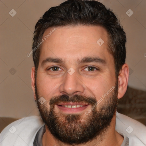 Joyful white adult male with short  brown hair and brown eyes