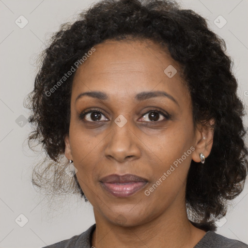 Joyful black adult female with medium  brown hair and brown eyes