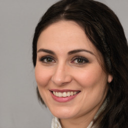 Joyful white adult female with medium  brown hair and brown eyes