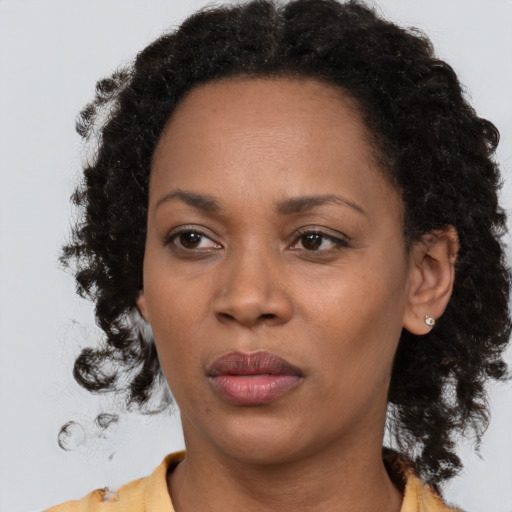 Neutral black adult female with long  brown hair and brown eyes