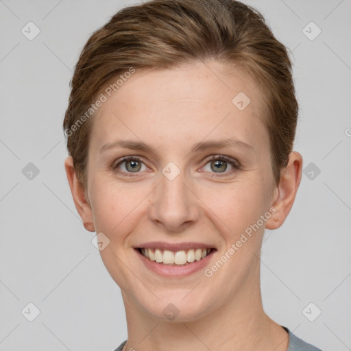 Joyful white young-adult female with short  brown hair and grey eyes