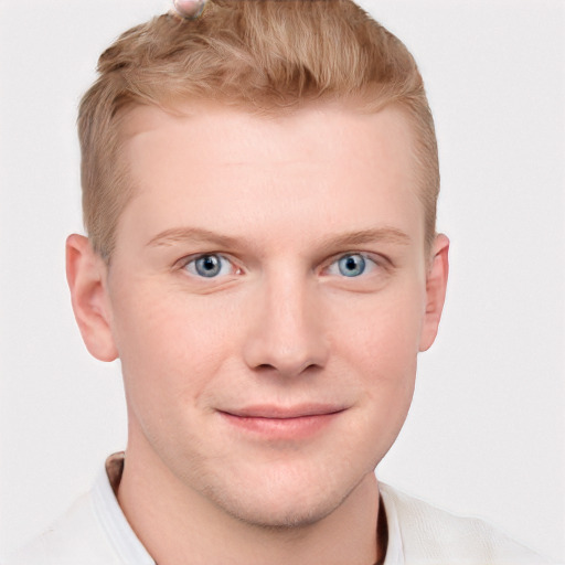 Joyful white young-adult male with short  brown hair and blue eyes