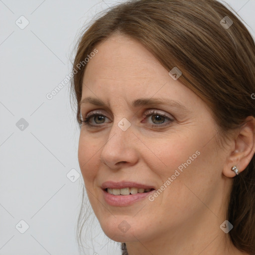 Joyful white adult female with long  brown hair and grey eyes