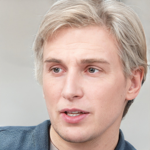 Joyful white adult male with short  brown hair and blue eyes