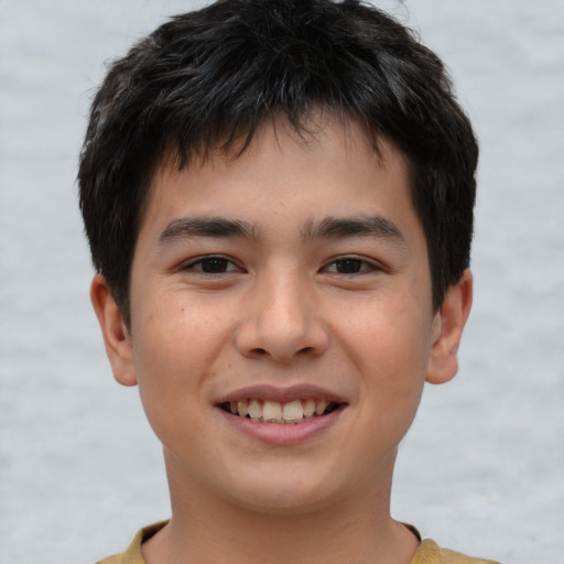 Joyful asian child male with short  brown hair and brown eyes