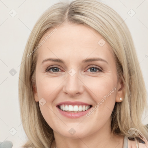 Joyful white young-adult female with long  brown hair and blue eyes